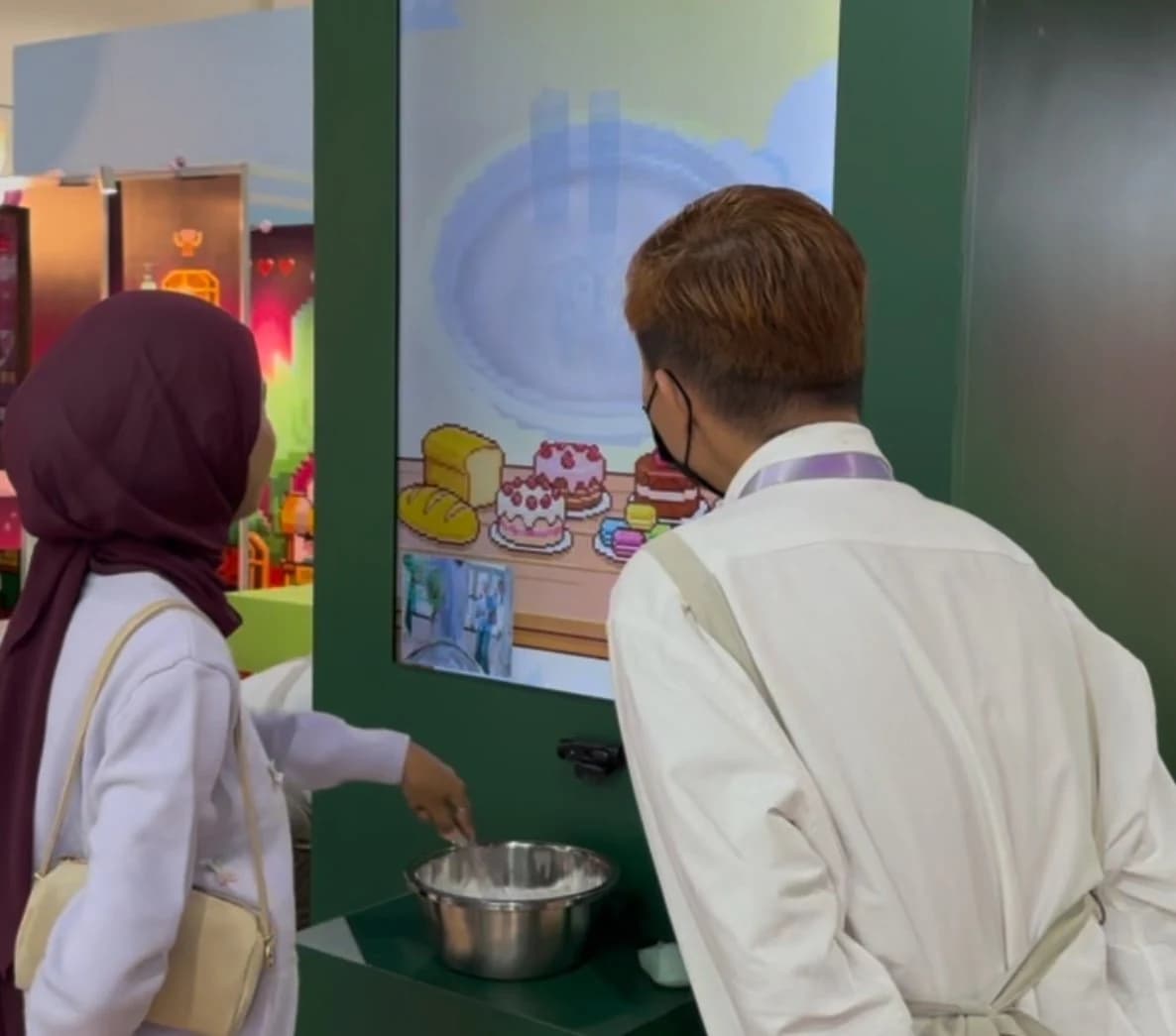 Visitors using a real bowl and whisk to play the Tous les Jours event game.