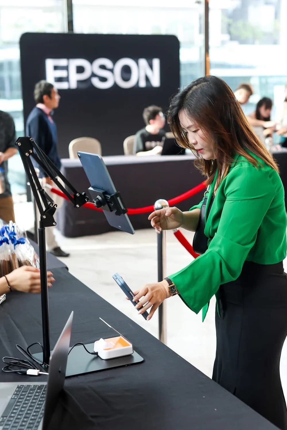 An attendee using an assisted QR check-in station at an event.